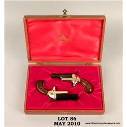 Pair of COLT derringers in presentation case, #  82038D and 82039D, .22 Short, enameled barrels  wit