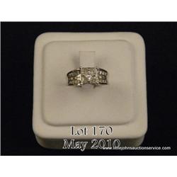 One ladies diamond ring set with assorted shapes  of diamonds princess, trilliants, and st.  baguett