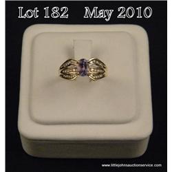 Stylish 14 karat yellow gold ladies ring set with  a center oval Tanzanite weighing approx. 1.00  ca