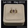 Image 1 : Stylish 14 karat yellow gold ladies ring set with  a center oval Tanzanite weighing approx. 1.00  ca