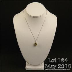 Brilliant 14 karat white gold ladies necklace set  with a center oval green/yellow quartz weighing  