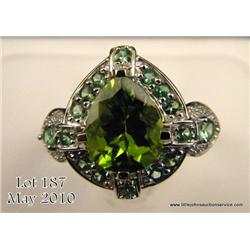 Marvelous 14 karat white gold ladies custom made  ring set with a center fine green Peridot weighing