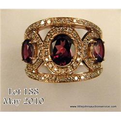 Sensational 14 karat rose gold ladies custom made  ring set with three fine oval cut intense purple 
