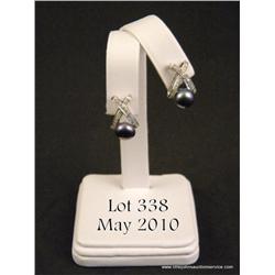 Beautiful 14 karat white gold ladies earrings set  with two black pearls of 8.50 MM in diameter and 