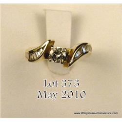 Ladies 14kt yellow gold diamond ring, center  approx. .33 carat and side baguettes approx. 0.50  car