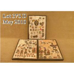 Three riker mounts containing various WWII German  military, veteran, and political badges. Also  in