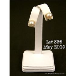 Stylish 10 karat yellow gold ladies earrings set  with two rose pink pearls averaging 8.00 mm in  di