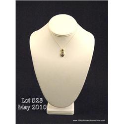 Very stylish 14 karat two-tone gold ladies pendant  set with a nice round Tanzanite a fine diamond. 