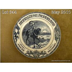 Blue and white ceramic plate depicting a Dutch  trumpeting nobleman on horseback trampling a flag  w