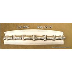 Spectacular 10 karat white gold ladies handmade  bracelet channel set with over 1,000 baguette cut  