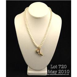 Stylish 14 karat yellow gold ladies designer pearl  necklace pave set with approx. 0.20 carats in  r