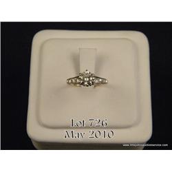 Ladies 14kt yellow gold ring with center diamond  weighing approx. 0.75 carat along with 6 small  si