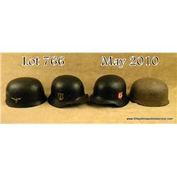 Lot of 4 German WWII helmets; two reproduction  German paratrooper helmets cleverly aged. A model  3