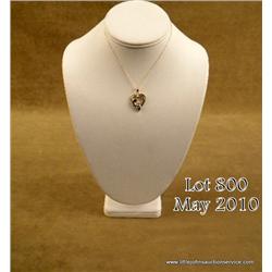 Charming 14 karat yellow gold ladies Madonna and  Child design pendant channel set with 20 baguette 