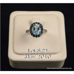 Gorgeous 10 karat white gold ladies ring set with  a center oval blue topaz weighing 3.50-4.00 carat
