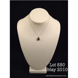 Dazzling 10 karat white gold ladies pendant set  with a center cushion cut purple Amethyst weighing 