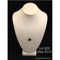 Fashionable 14 karat yellow gold ladies handmade  ladies pendant set with a center cushion cut  quar