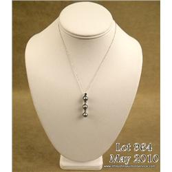 Elegant 14 karat white gold ladies pendant set  with three round gray/black pearls averaging 7.00  m