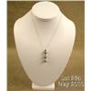 Elegant 14 karat white gold ladies pendant set  with three round gray/black pearls averaging 7.00  m