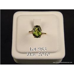 Elegant 10 karat yellow gold ladies ring set with  a center very fine green Peridot weighing approx.