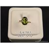 Image 1 : Elegant 10 karat yellow gold ladies ring set with  a center very fine green Peridot weighing approx.