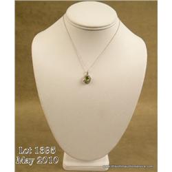 Elegant 10 karat two-tone gold ladies pendant set  with a center green Peridot weighing over 1.50  c
