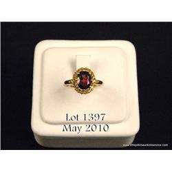 Marvelous 10 karat yellow gold ladies ring set  with a center oval garnet weighing approx. 2.00  car