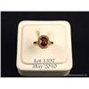 Marvelous 10 karat yellow gold ladies ring set  with a center oval garnet weighing approx. 2.00  car