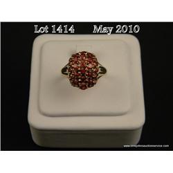Stylish 10 karat yellow gold ladies dome design  ring set with 33 fine orange red garnets weighing  