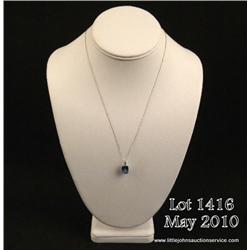 Wonderful 10 karat white gold ladies necklace set  with a center checkerboard cut sky blue topaz  we