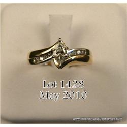 Ladies 14kt yellow gold ring set with one marquise  cut weighing approx. .33 carat with small  diamo