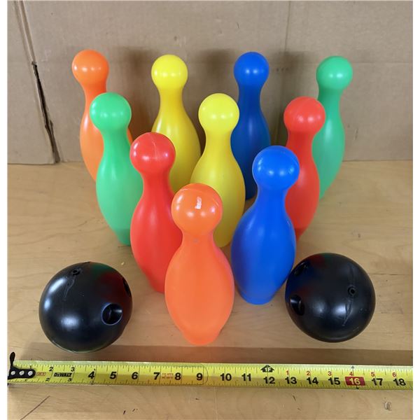 Kids 10 colorful, lightweight bowling pins and two black bowling balls.