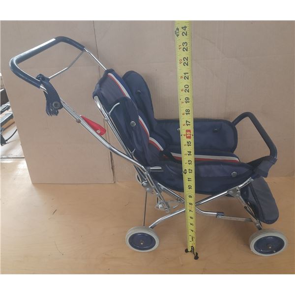 Vintage Hedstrom baby doll stroller featuring a chrome frame and navy blue fabric.