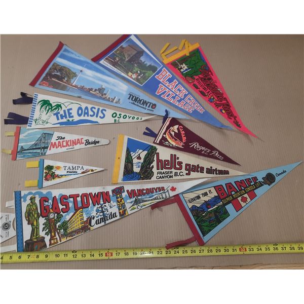 Vintage felt pennants from the 1950s-1970s celebrate Canadian tourist destinations like Banff, Vanco