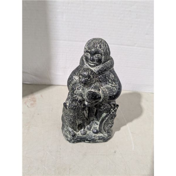 Soapstone carving, eskimo with dogs