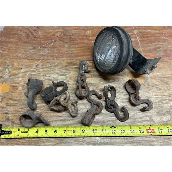 Vintage and antique farm implement hardware, including hand-forged iron harness parts, single-tree/d
