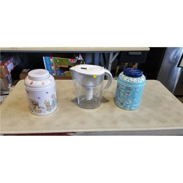 2 TINS OF PETER RABBIT ENGLISH BREAKFAST TEA AND KIRKLAND WATER PITCHER