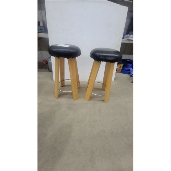 Pair of Bar Stools with Round Black Padded Seats, Wooden Legs, and Metal Footrests