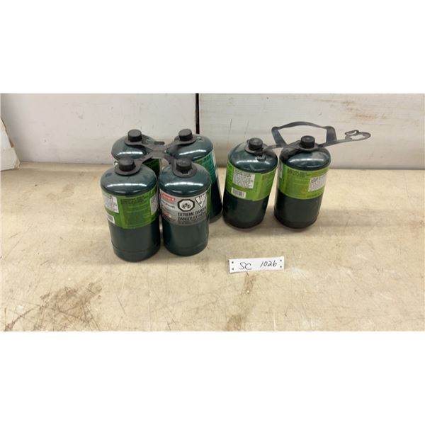 Six Coleman 16 oz (1 lb) propane camping gas cylinders.