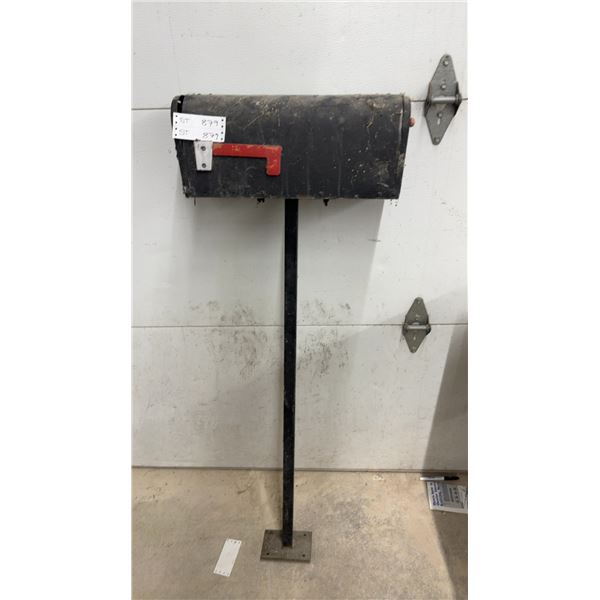 Black Metal Mailbox on Post with Red Flag and White Label