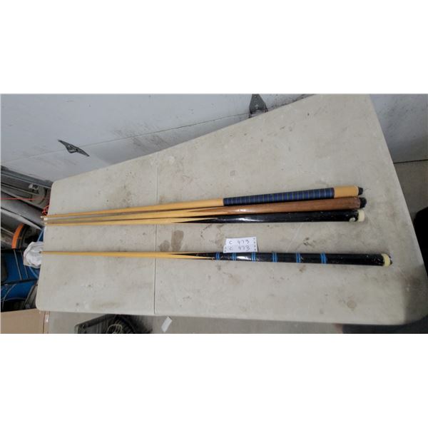 Set of Four Wooden Billiards Cues with Striped, Black, and Natural Wood Handle Designs