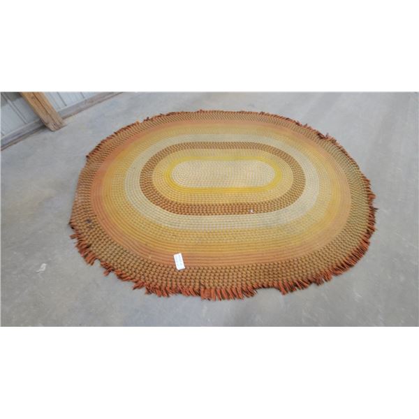 Oval Braided Area Rug with Concentric Yellow, Orange, and Brown Bands and Fringed Edge 106”×84”