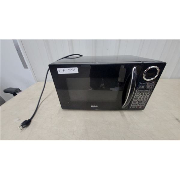 RCA Black Countertop Microwave Oven with Digital Display and Preset Cooking Controls