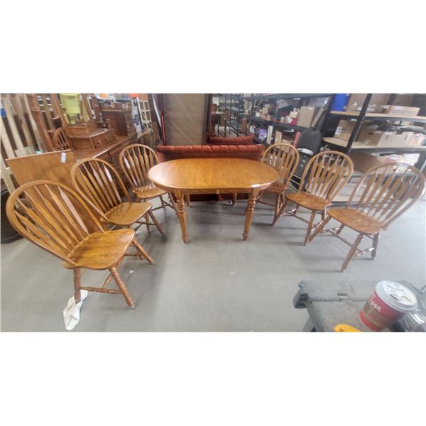 Oval Oak Dining Table With Leaf and Six Windsor-Style Slat-Back Chairs