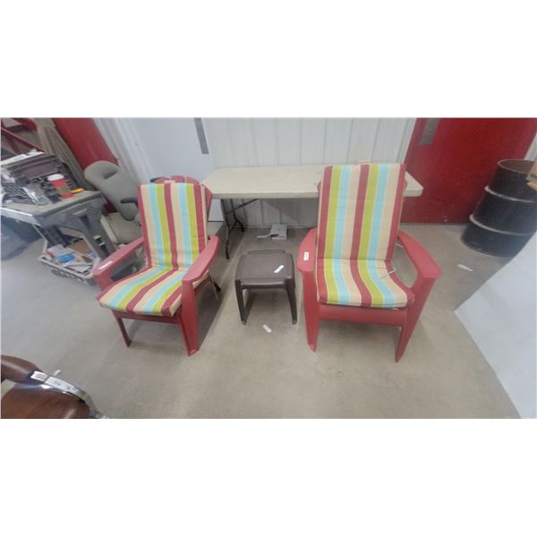 Pair of Red Plastic Adirondack Patio Chairs With Striped Cushions and Brown Side Table