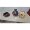 Image 1 : Handcrafted Pottery Lot: Carved Face Jar, Dark Globular Vase, and Reddish-Brown Bowl