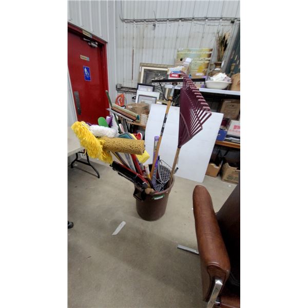 Brown Plastic Utility Bucket with Assorted Long-Handled Tools, Rakes, Brooms, Shovel