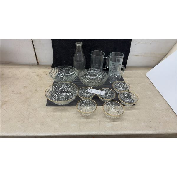 Assorted Clear Glassware Including Pitchers, Bottle, and Gold-Rimmed Starburst Bowl Set