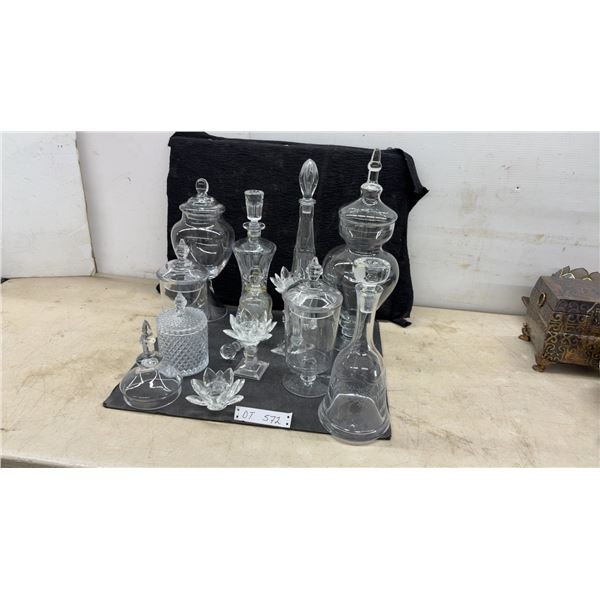 Assorted Clear Glass Lidded Apothecary Jars, Decanters With Stoppers, and Lotus Candle Holders