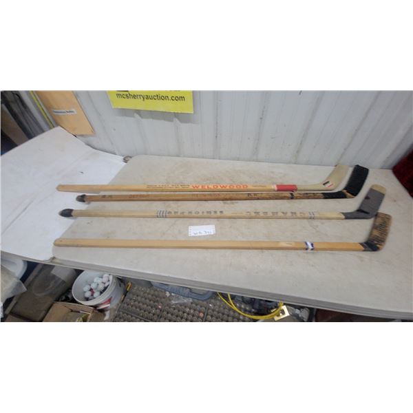 Four Hockey Sticks: Weldwood, Senior Pro Chambec, Detroit Redwings, and Unbranded